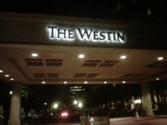 Illuminated building sign at night — The Westin