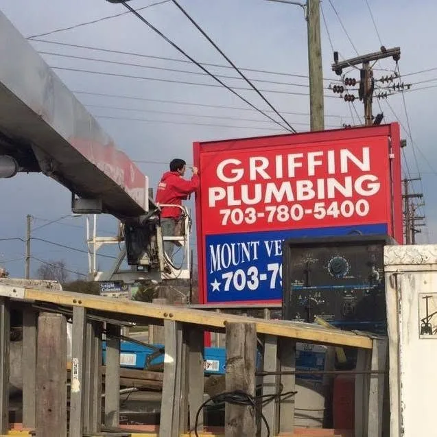 Installing a sign with a bucket truck — Griffin Plumbing