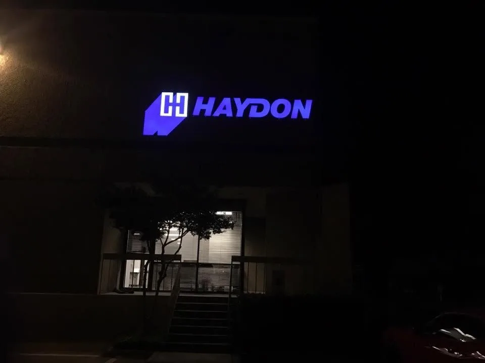 Illuminated storefront sign lit at night